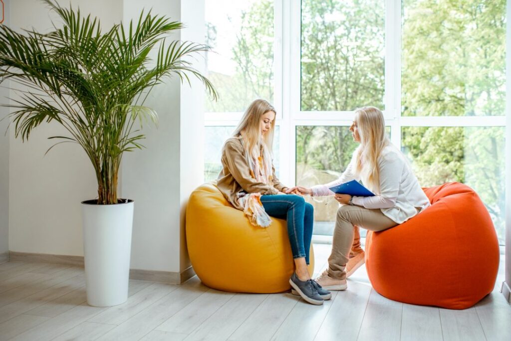 A woman engages in conversation with another woman